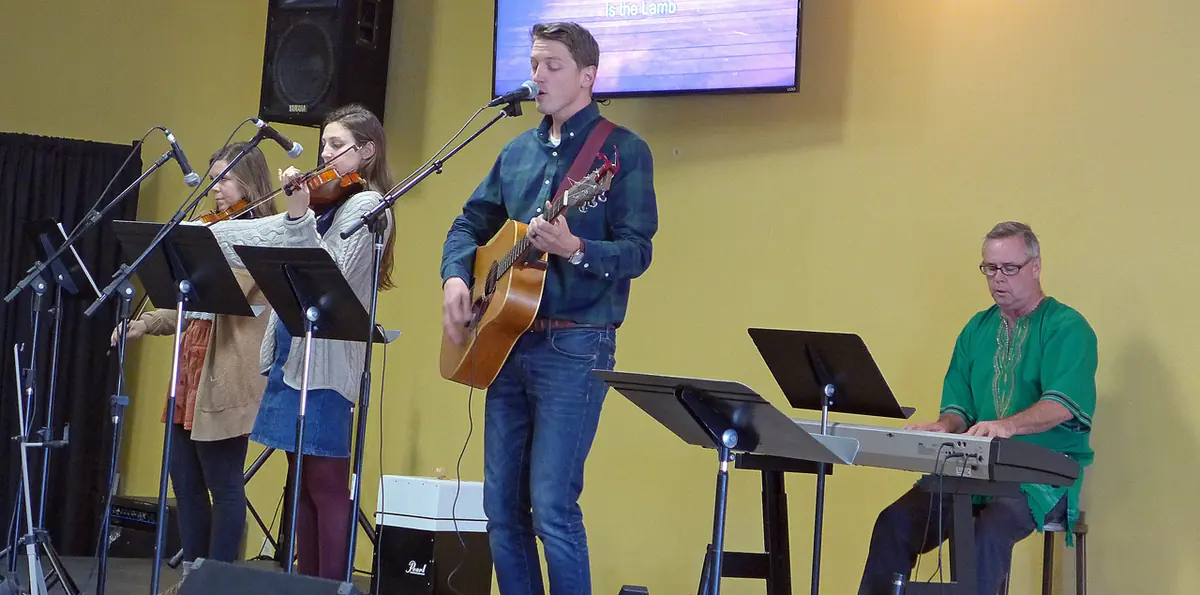 The Oasis Community Church congregation worshipping together